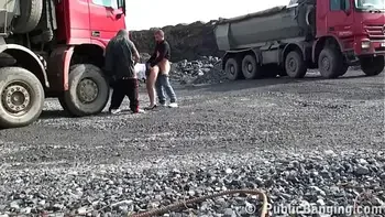 A very cute blonde young lady is fucked in public threesome at a construction site
