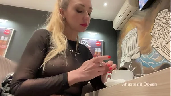 Flashing her big boobs in transparent top in public cafe.