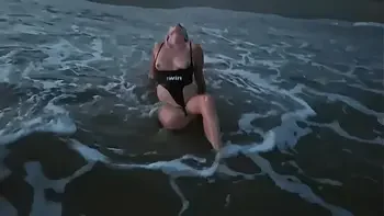 Blonde shows tits and sucks cock on a public beach