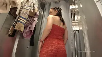 I try on clothes in fitting room with open curtain.