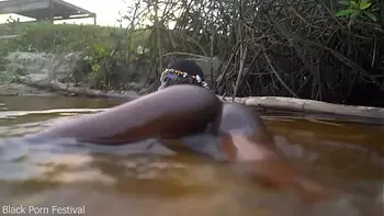 Skinny dark skinned African hottie teasing in the water