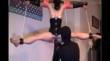 Restrained, bound, legs spread & suspended from ceiling. Masked vagina fisting.