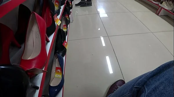 Voyeur and foot fetish in a public place. Beautiful legs in stockings and a juicy ass under a short dress in a shoe store.