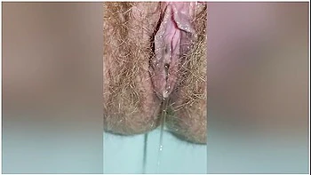 Detailed Close-up Footage Of A Hairy Pussy Girl Urinating From Her Pee Hole And Farting Loudly