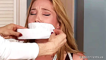 Janira tied and gagged on chair.