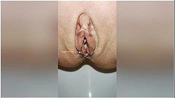 Beautiful Bald Pussy Of Petite Milf Makes The Big Powerful Urine Fountain Close Up