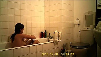 Brunette babe gets wet in steamy bathroom shower