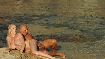 Two hot babes suck and ride cock on the beach